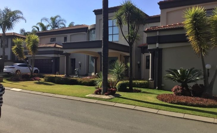 Front view of a luxurious 4-bedroom house for sale in Sunward Park, Boksburg with landscaped garden and double garage.